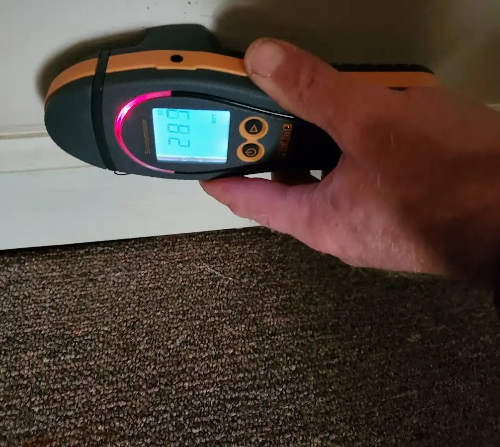 Moisture detection at baseboard during Storm Damage Restoration in Deming